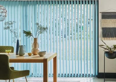 Bright blue vertical blinds for a patio door in a dining room setting