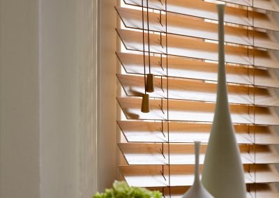 Orange/brown faux wood venetian blind closeup