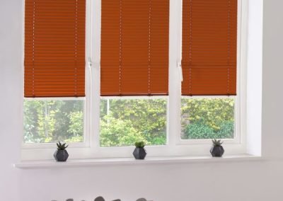 Burnt orange perfect fit® blinds in a kitchen setting